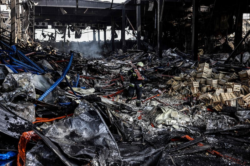 A rescuer clears the rubble of a warehouse containing more than 50,000 tons of deep-frozen food in the town of Brovary, north of Ukrainian capital of Kyiv, after it was destroyed by Russian shelling. AFP