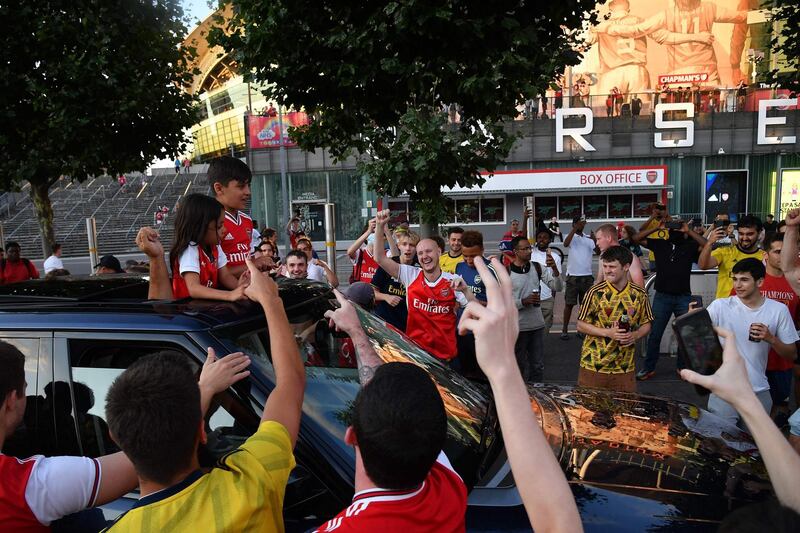 Arsenal fans celebrate outside the Emirates stadium. AFP