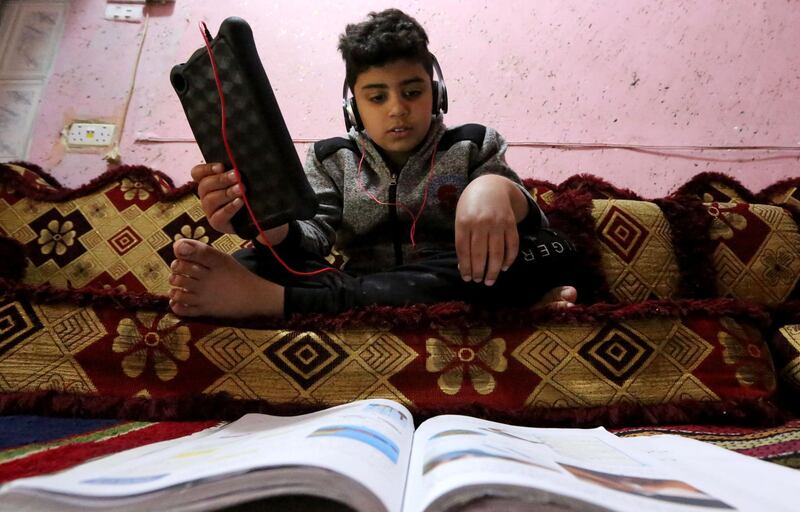 An Iraqi school boy studies remotely using a tablet in Baghdad.  AFP
