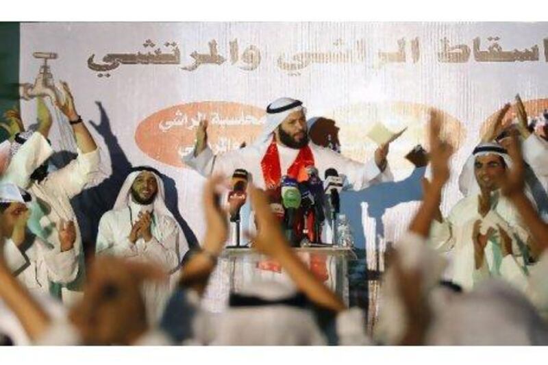 The Kuwaiti Islamist opposition MP Faisal Al Muslim addresses a protest in front of the parliament in Kuwait City. Yasser Al-Zayyat / AFP
