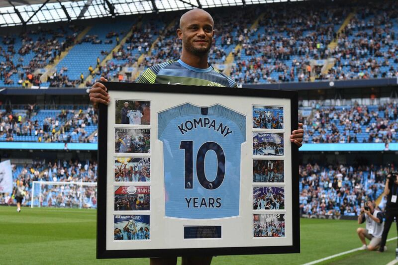 Manchester City's Belgian defender Vincent Kompany poses with a framed shirt and pictures celebrating his 10 years with the club ahead of the English Premier League football match between Manchester City and Newcastle United at the Etihad Stadium in Manchester, north west England, on September 1, 2018. (Photo by Oli SCARFF / AFP) / RESTRICTED TO EDITORIAL USE. No use with unauthorized audio, video, data, fixture lists, club/league logos or 'live' services. Online in-match use limited to 120 images. An additional 40 images may be used in extra time. No video emulation. Social media in-match use limited to 120 images. An additional 40 images may be used in extra time. No use in betting publications, games or single club/league/player publications. / 