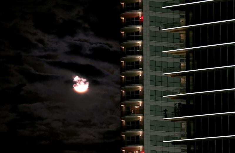 The supermoon sits among the clouds over the Beirut skyline in Lebanon. Nabil Mounzer / EPA