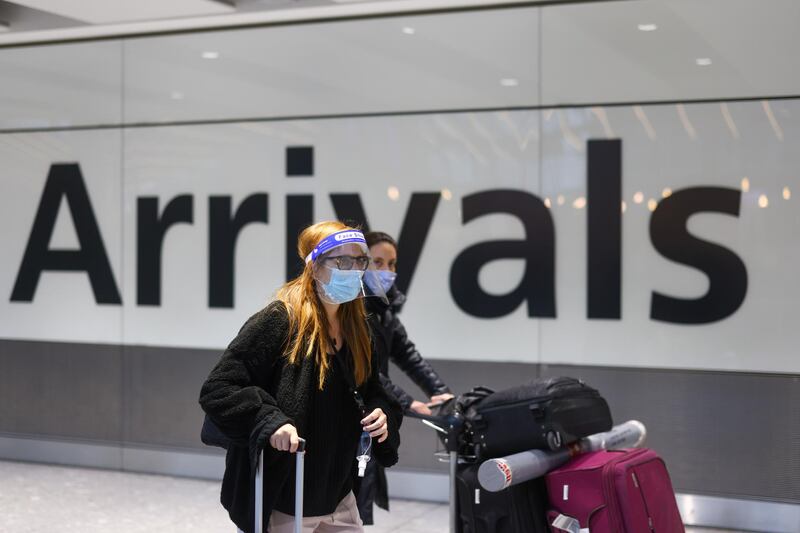 Travelers arrive at London Heathrow Airport in London, U.K., on Monday, Jan. 18, 2021. U.K. ministers have closed travel corridors with other countries from Monday, meaning that all visitors from overseas will require a negative test result within 72 hours of travel to enter Britain. Photographer: Simon Dawson/Bloomberg