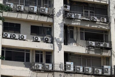 Air conditioning units hang from a building during high temperatures in New Delhi. Bloomberg
