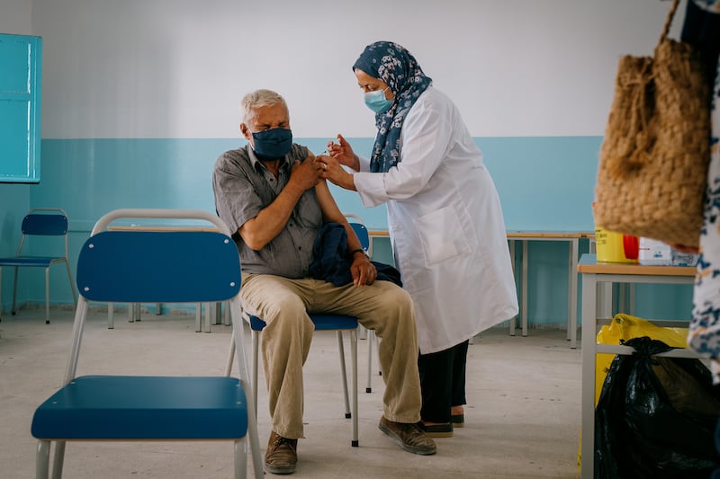 Ahmed Nursutlan, 78, said his family persuaded him to overcome his fear of needles to get the vaccine. "It was time," he said.