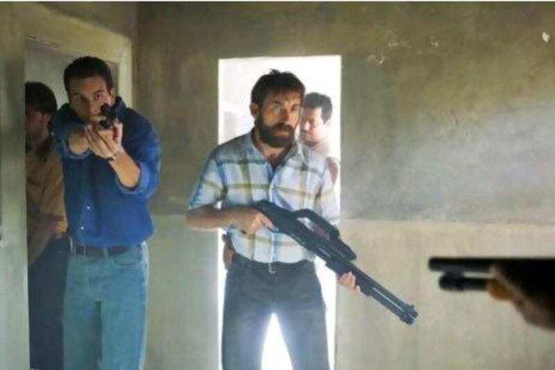 Characters in a scene from the Spanish movie Grupo 7 (Unit 7) from left, Angel (played by Mario Casas), and Rafael (Antonio de la Torre).