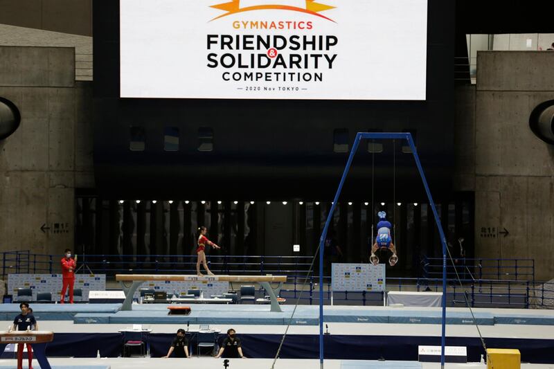 Gymnasts warm up before competing in Tokyo. AP