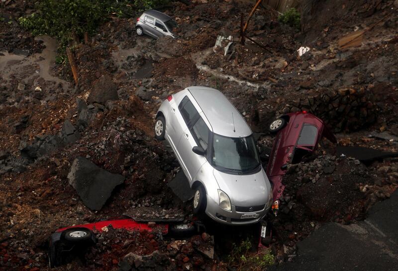 Cars amid debris after a wall collapse in Mumbai, India. Francis Mascarenhas / Reuters