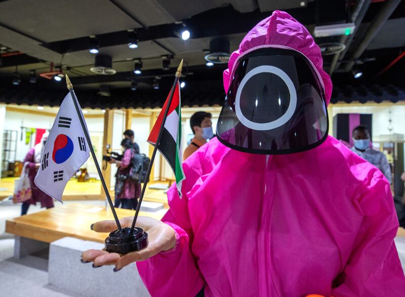 A Squid Game guard holds up the South Korean and UAE flags at the Korean Cultural Centre
