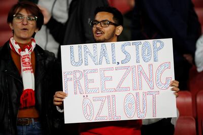 Soccer Football - Europa League - Group F - Arsenal v Vitoria S.C. - Emirates Stadium, London, Britain - October 24, 2019  A fan holds up a banner referencing Arsenal's Mesut Ozil   Action Images via Reuters/Andrew Boyers