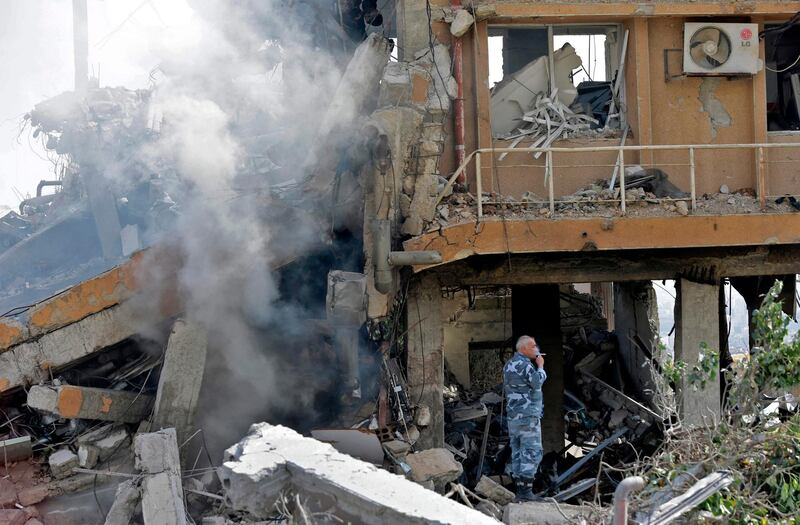 A Syrian soldier inspects the wreckage of a building described as part of the Scientific Studies and Research Centre (SSRC) compound in the Barzeh district, north of Damascus, during a press tour organised by the Syrian information ministry, on April 14, 2018.
The United States, Britain and France launched strikes against Syrian President Bashar al-Assad's regime early on April 14 in response to an alleged chemical weapons attack after mulling military action for nearly a week. Syrian state news agency SANA reported several missiles hit a research centre in Barzeh, north of Damascus, "destroying a building that included scientific labs and a training centre".  AFP PHOTO / LOUAI BESHARA
