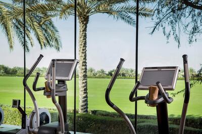 A gym with a view of the verdant fields in the distance. Courtesy of Melia Desert Palm Dubai