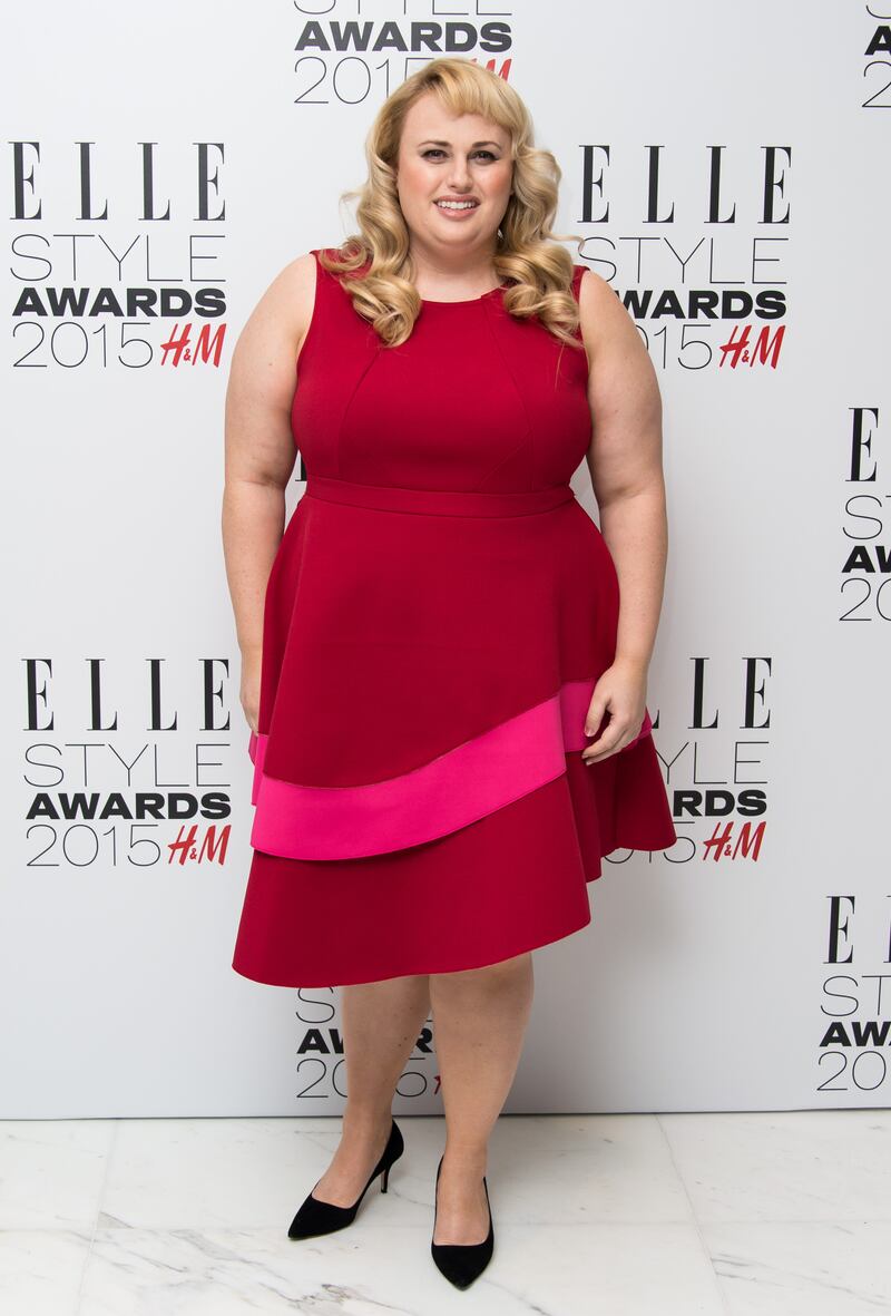 Rebel Wilson, in a red and pink prom-style dress, attends the Elle Style Awards in London on February 24, 2015. Getty Images