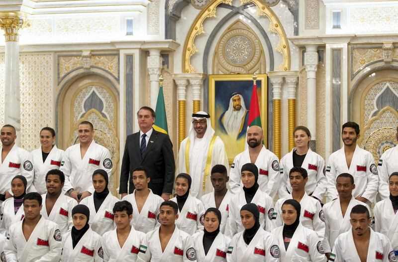 ABU DHABI, UNITED ARAB EMIRATES - October 27, 2019: HH Sheikh Mohamed bin Zayed Al Nahyan, Crown Prince of Abu Dhabi and Deputy Supreme Commander of the UAE Armed Forces (5th L) and HE Jair Bolsonaro, President of Brazil (4th L) stand for a photograph with Jiu Jitsu athletes during a reception, at Qasr Al Watan.

( Abdullah Al Nayadi for the Ministry of Presidential Affairs )
---