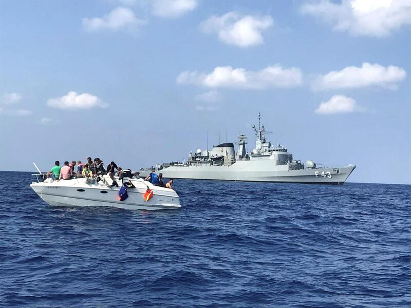 In this photo taken Thursday, Oct. 11 and released Friday Thursday, Oct. 12, 2018 by United Nations Interim Force in Lebanon (UNIFIL), UNIFIL's flagship, BRS Liberal, approaches a boat overcrowded with migrants in the Mediterranean Sea. The U.N. peacekeeping force in Lebanon says it has helped in rescuing 32 migrants on a boat who were trying to reach the Mediterranean island of Cyprus. The force known as UNIFIL said on Friday that migrants who were rescued the day before were 19 men, six women and seven children.(UNIFIL via AP)