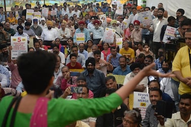 Customers and depositors of the Punjab and Maharashtra Co-operative (PMC) Bank attend a protest demanding to get their money back after an alleged 43.55 billion rupees (614 million USD) scam, in Mumbai on October 30, 2019. / AFP / Punit PARANJPE