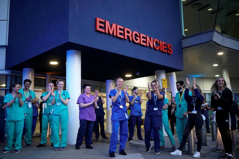 LIVERPOOL,  - APRIL 09: NHS staff applaud themselves and their colleagues at the entrance of the Royal Liverpool Hospital as part of the "Clap For Our Carers" campaign on April 09, 2020 in Liverpool, United Kingdom. Following the success of  the "Clap for Our Carers" campaign, members of the public are being encouraged to applaud NHS staff and other key workers from their homes at 8pm every Thursday. The Coronavirus (COVID-19) pandemic has infected over 1.5 million people across the world, claiming over 7,978 lives in the U.K.. (Photo by Christopher Furlong/Getty Images)