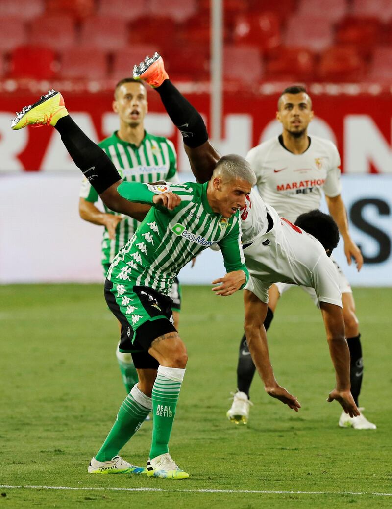 Real Betis' Cristian Tello  battles for the ball with Jules Kounde of Sevilla. Reuters