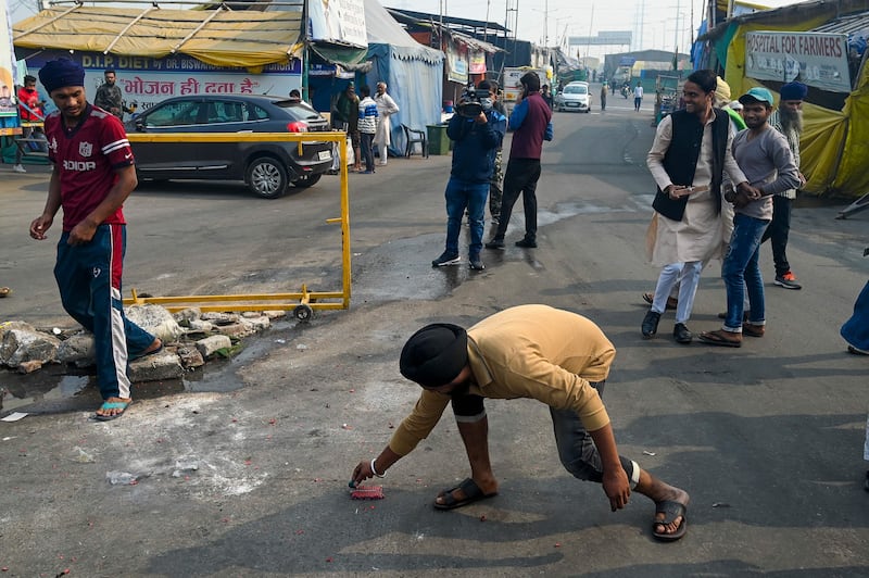 Ghaziabad farmers light firecrackers in celebration of the laws being repealed. AFP