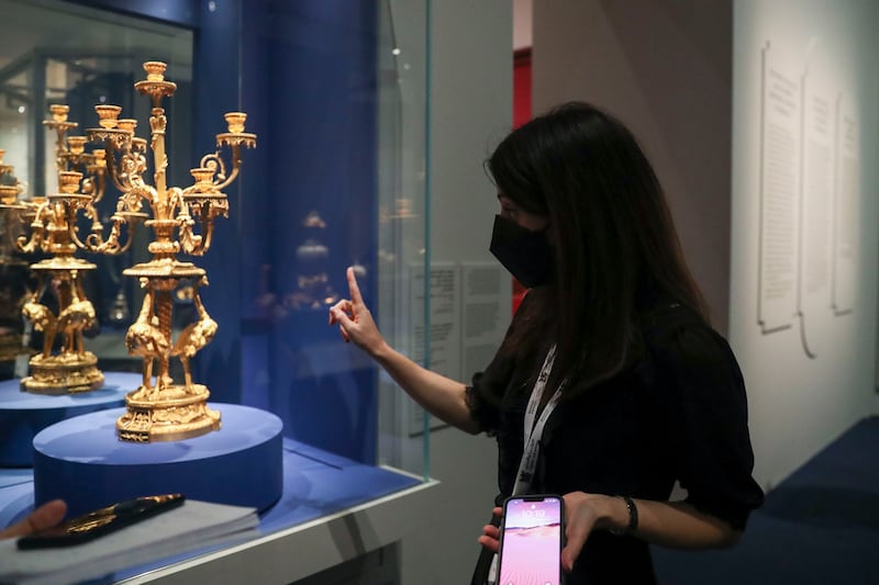 Curator Helene Delalex explains about the seven-branch ostrich candlestick from the second Turkish Cabinet of the Count of Artois, brother of Louis XVI at the Chateau de Versailles.