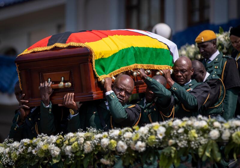 The casket of former president Robert Mugabe is carried by the presidential guard to an air force helicopter for transport to a stadium where it will lie in state, at his official residence in the capital Harare, Zimbabwe. The ongoing uncertainty of the burial of Mugabe, who died last week in Singapore at the age of 95, has eclipsed the elaborate plans for Zimbabweans to pay their respects to the former guerrilla leader at several historic sites. AP Photo