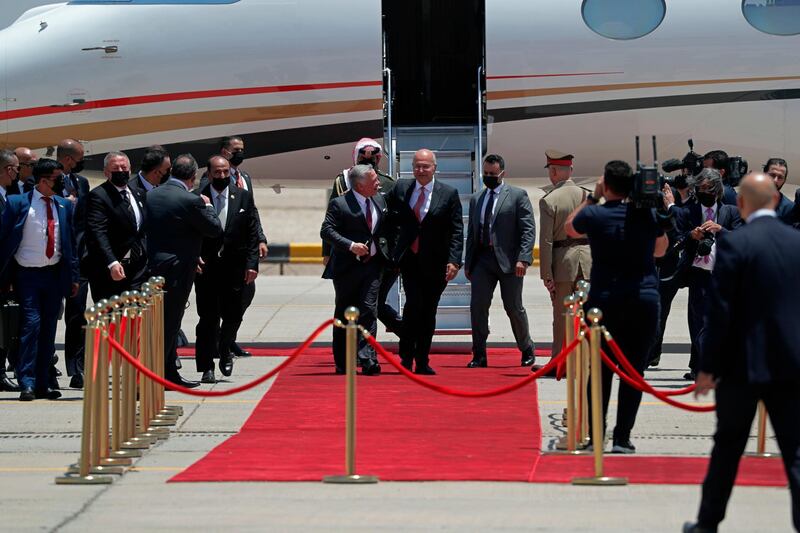 Iraqi President Barham Salih welcomes Jordan's King Abdullah II upon his arrival at Baghdad Airport. AP