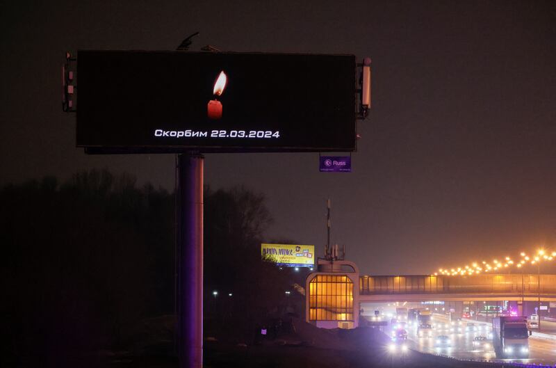 A digital board with a date and a slogan that reads 'We mourn'  opposite Crocus City Hall. Reuters