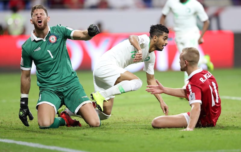 Saudi Arabia's Hussain Al Moqahwi, right, celebrates after scoring against Lebanon at Al Maktoum Stadium in Dubai. Reuters