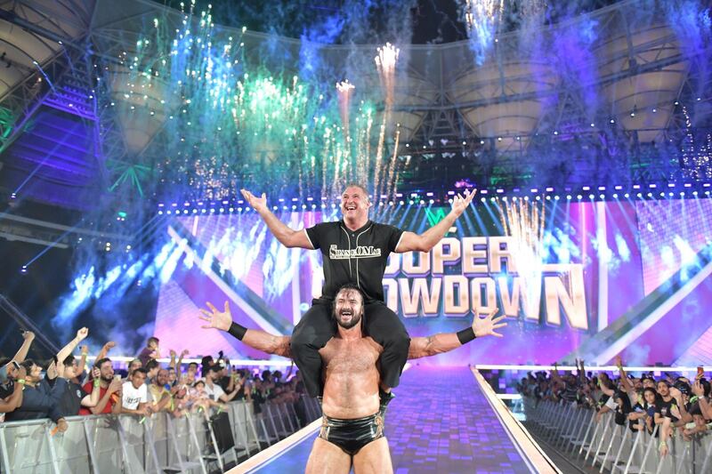 Shane McMahon celebrates beating Roman Reigns at WWE Super ShowDown on the shoulders of Drew McIntyre. Image courtesy of WWE