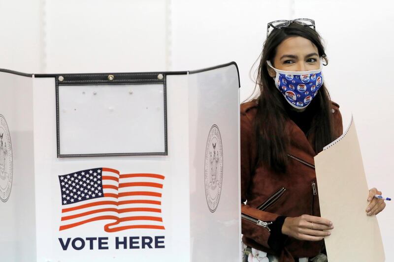 Congresswoman Alexandria Ocasio-Cortez holds her filled ballot as she votes early at a polling station in The Bronx, New York City, U.S. REUTERS