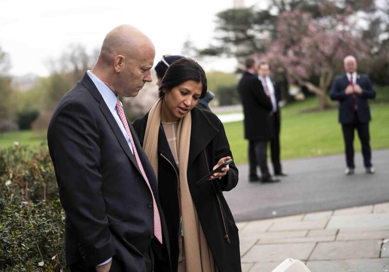 (FILES) In this file photo taken on March 24, 2020 Marc Short, Chief of Staff for Vice President Mike Pence (L) talks with Katie Miller, Vice President Mike Pence's press secretary as President Donald Trump and Vice President Mike Pence as participate in a Fox News Virtual Town Hall with Anchor Bill Hemmer, in the Rose Garden of the White House in Washington, DC. The US vice president's spokeswoman Katie Miller became the second White House staffer this week to test positive for coronavirus, officials said on May 8, 2020, even as President Donald Trump continued to go mask-free at a World War II commemoration with veterans in their 90s. News that staffer Katie Miller had fallen ill boosted fears that the White House is at risk of becoming a viral hot spot just when Trump is leading efforts to wind down nationwide quarantine measures that have devastated the world's biggest economy. / AFP / GETTY IMAGES NORTH AMERICA / Doug MILLS

