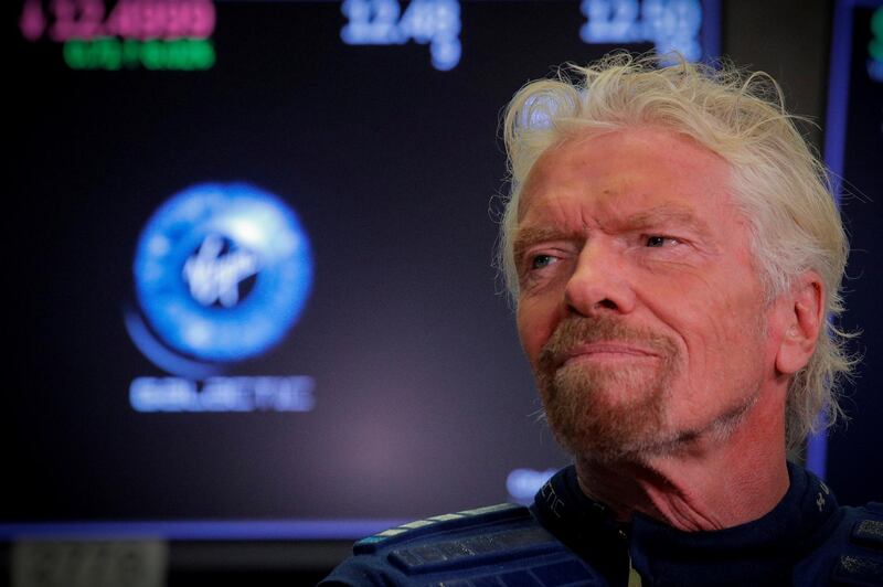 FILE PHOTO: Sir Richard Branson stands on the floor of the New York Stock Exchange ahead of the start of trading in Virgin Galactic in New York, Oct. 28, 2019. REUTERS/Brendan McDermid/File Photo