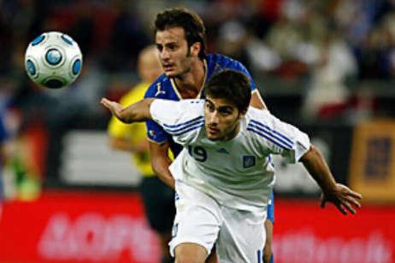 Italy's Alberto Gilardino jostles with Greece's Sokratis Papstathopoulous.