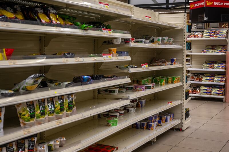 Supermarket shelves containing dry goods are left depleted in Tel Aviv. Getty Images