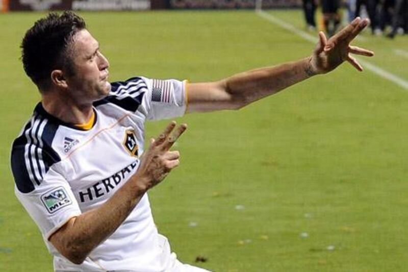 CARSON, CA - AUGUST 20: Robbie Keane #14 of the Los Angeles Galaxy celebrates his goal in his debut game for a 1-0 lead over the San Jose Earthquakes as Landon Donovan #10 looks on during the first half at The Home Depot Center on August 20, 2011 in Carson, California.   Harry How/Getty Images/AFP