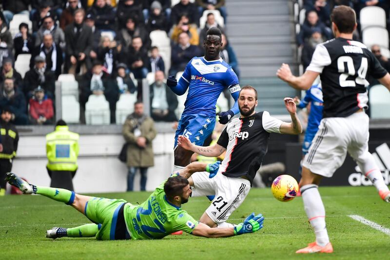 Juventus' Gonzalo Higuain and Brescia's Enrico Alfonso vie for the ball. AP