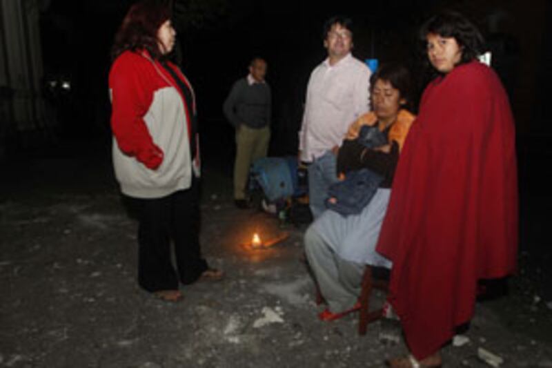 Residents gather outside their house  in Santiago after an 8.8-magnitude earthquake struck central Chile.