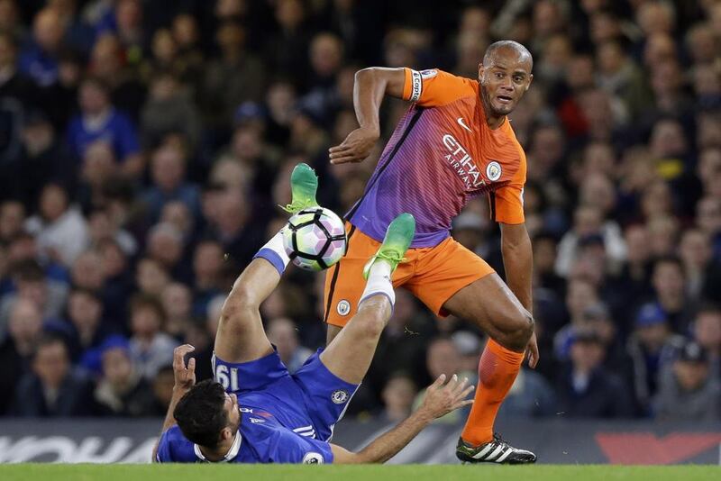 Manchester City's Vincent Kompany, right, fights for the ball with Chelsea's Diego Costa. Alastair Grant / AP