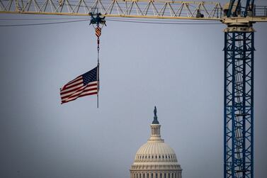 An American flag flies from a construction crane in front of the U. S.  Capitol in Washington, D. C. , U. S. Photographer: Al Drago / Bloomberg