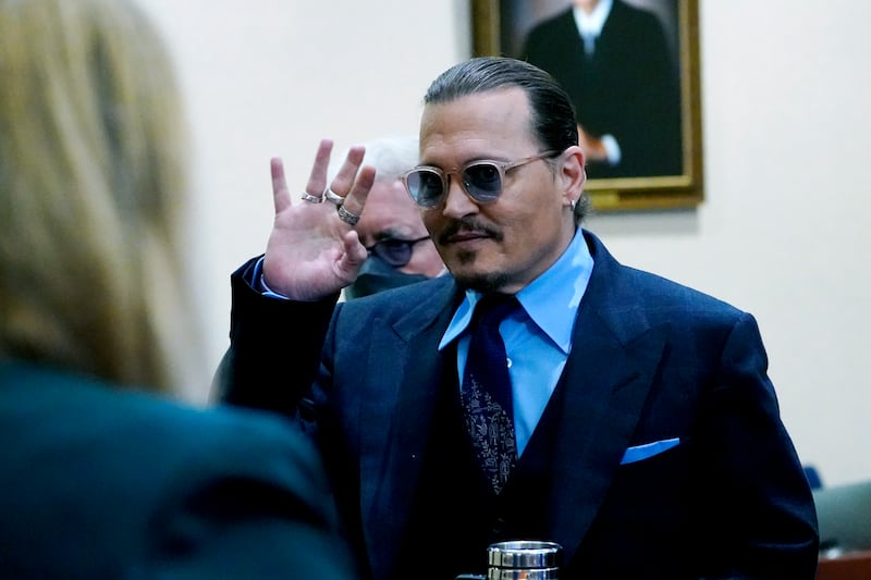 US actor Johnny Depp waves to spectators in the courtroom at the Fairfax County Circuit Court in Fairfax, Virginia on Monday. EPA