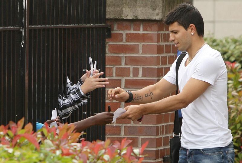 Sergio Aguero signs autographs after completing his medical following his move to Manchester City in July, 2011. PA