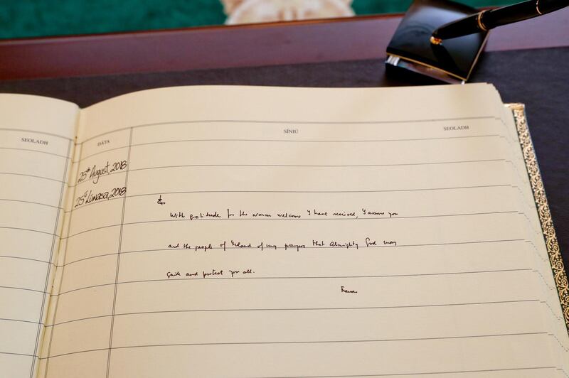 Pope Francis leaves a message when signing the visitors book in Aras an Uachtarain. EPA