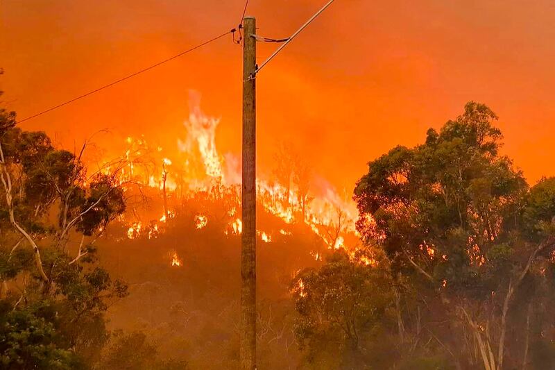 Fire burns on a hill at Wooroloo, near Perth. AP