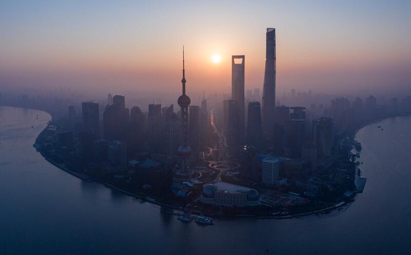 The sun rising behind the skyline of Shanghai's Lujiazui Financial District of Pudong. AFP