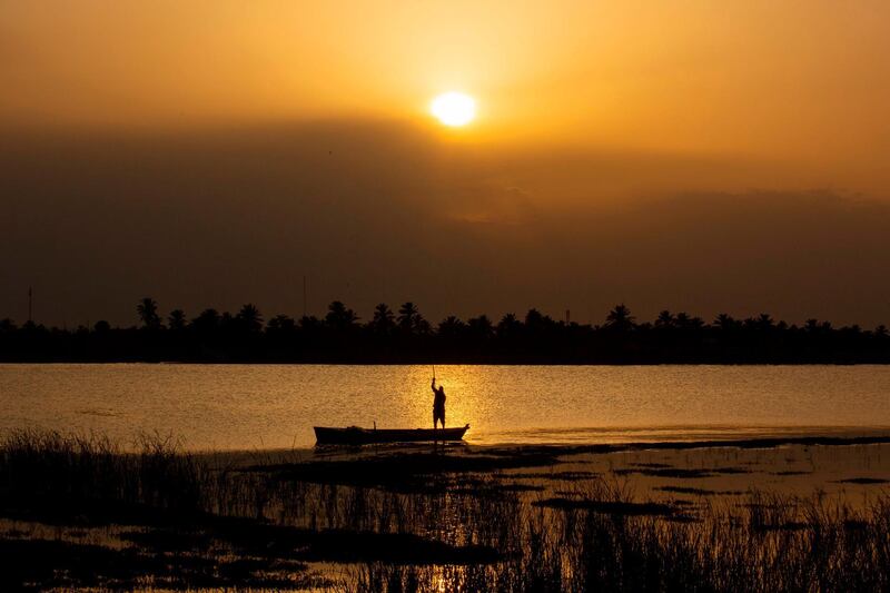 An Iraqi man fishes at the Shatt Al Arab river, formed by the confluence of the Euphrates and the Tigris, near Basra.  AFP