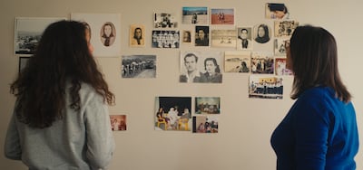 Lina and her mother look at a collage of old photos. Photo: Beall Productions