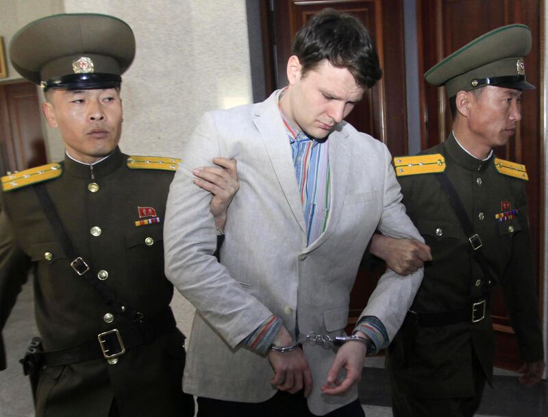 FILE - In this March 16, 2016, file photo, American student Otto Warmbier, center, is escorted at the Supreme Court in Pyongyang, North Korea. The death last week of American student Warmbier, who fell into a coma after being arrested in North Korea, has raised questions about whether his tour agency was adequately prepared for its trips into the hard-line communist state. The Young Pioneer Tours agency built up a business attracting young travelers with cut-rate, hard-partying adventures into one of the worldâ€™s most isolated countries. (AP Photo/Jon Chol Jin, File)