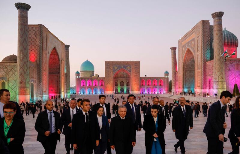 France's President Emmanuel Macron, centre left, and Uzbekistan's President Shavkat Mirziyoyev, centre right, visit  Registan Square in Samarkand. AFP