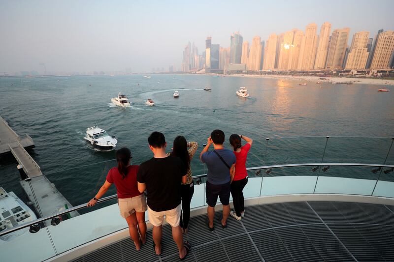 Dubai, United Arab Emirates - September 21, 2019: Standalone. Tourists look at JBR on a humid day in Dubai. Saturday the 21st of September 2019. Bluewaters, Dubai. Chris Whiteoak / The National