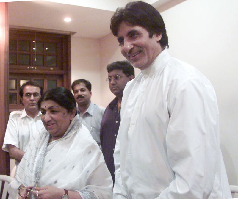 Mangeshkar with Bollywood actor Amitabh Bachchan in Mumbai in 2000. Mangeshkar holds a Guinness World Record for her more than 50,000 film tracks sung in 20 languages. Reuters